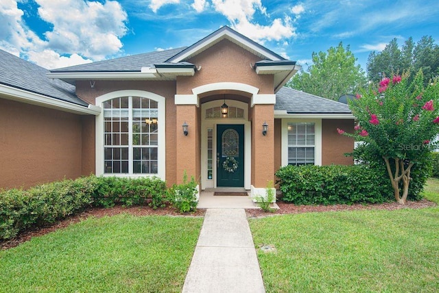 572 Sparrow Branch Cir, Saint Johns, FL 32259 - view of front of house featuring stucco siding, a shingled roof, and a front yard