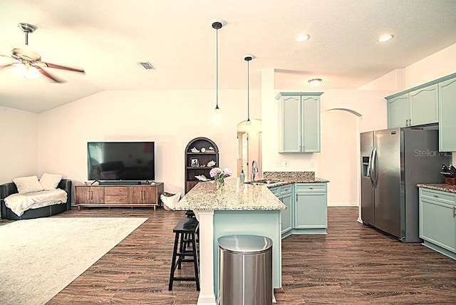 572 Sparrow Branch Cir, Saint Johns, FL 32259 - kitchen featuring a peninsula, stainless steel refrigerator with ice dispenser, dark wood-type flooring, a ceiling fan, and lofted ceiling