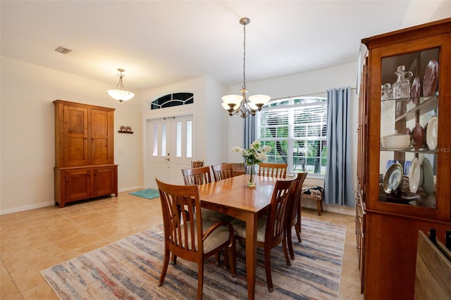 5242 Abdella Ln, North Port, FL 34291 - dining area with light tile patterned floors and a chandelier