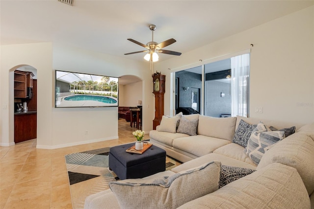 5242 Abdella Ln, North Port, FL 34291 - living room with arched walkways, tile patterned flooring, and a ceiling fan