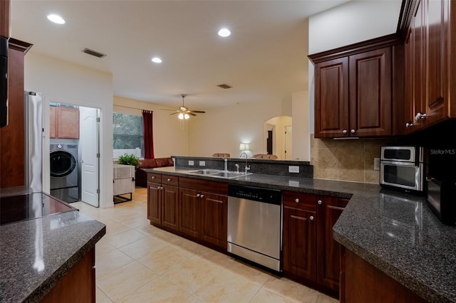 5242 Abdella Ln, North Port, FL 34291 - kitchen with dishwasher, washer / clothes dryer, ceiling fan, arched walkways, and dark countertops