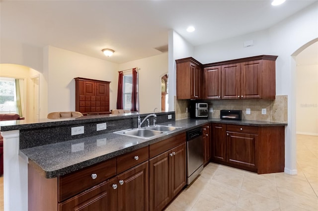 5242 Abdella Ln, North Port, FL 34291 - kitchen featuring arched walkways, stainless steel dishwasher, a peninsula, light tile patterned floors, and recessed lighting