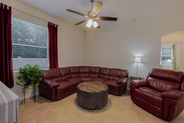 5242 Abdella Ln, North Port, FL 34291 - living area featuring arched walkways, a ceiling fan, and light tile patterned floors