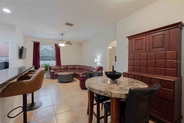 5242 Abdella Ln, North Port, FL 34291 - dining space featuring light tile patterned flooring, arched walkways, and ceiling fan