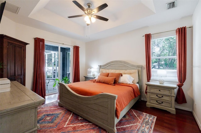 5242 Abdella Ln, North Port, FL 34291 - bedroom featuring a raised ceiling, access to exterior, dark wood-style floors, and ceiling fan