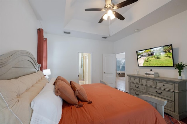 5242 Abdella Ln, North Port, FL 34291 - bedroom featuring a raised ceiling, ensuite bath, and ceiling fan