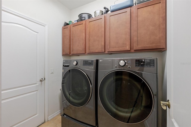 5242 Abdella Ln, North Port, FL 34291 - laundry room with cabinet space, washer and clothes dryer, and light tile patterned floors