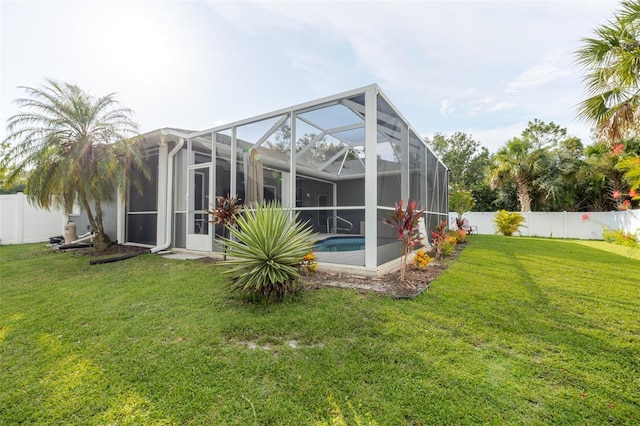5242 Abdella Ln, North Port, FL 34291 - back of house with a fenced backyard and glass enclosure