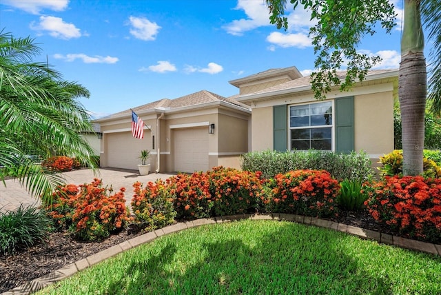 12215 Goldenrod Ave, Bradenton, FL 34212 - view of front of property featuring stucco siding, an attached garage, and concrete driveway