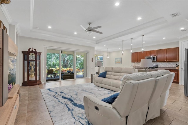12215 Goldenrod Ave, Bradenton, FL 34212 - living room featuring a tray ceiling, ceiling fan, light tile patterned floors, recessed lighting, and crown molding