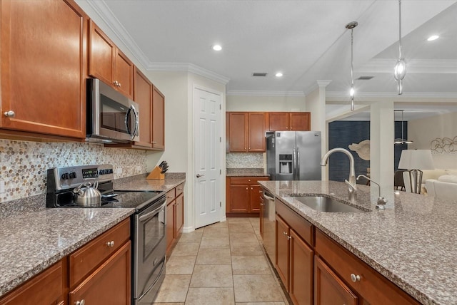 12215 Goldenrod Ave, Bradenton, FL 34212 - kitchen featuring appliances with stainless steel finishes, backsplash, light stone counters, brown cabinets, and crown molding