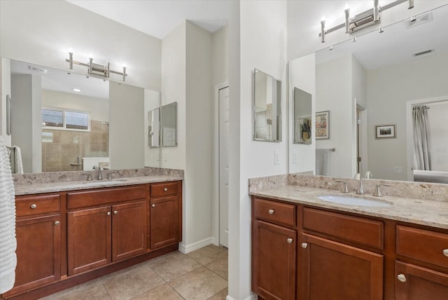 12215 Goldenrod Ave, Bradenton, FL 34212 - bathroom with two vanities, tiled shower, and tile patterned flooring