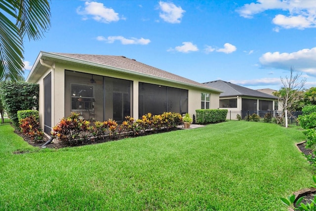 12215 Goldenrod Ave, Bradenton, FL 34212 - rear view of house with a sunroom, stucco siding, and ceiling fan