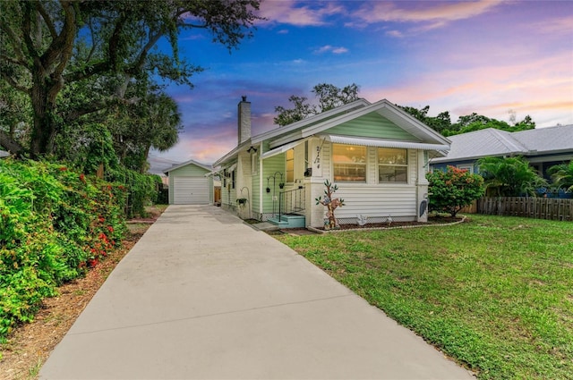 2124 6th Ave W, Bradenton, FL 34205 - view of front of property featuring a chimney, an outdoor structure, driveway, and a detached garage