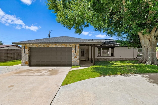 3136 Webber St, Sarasota, FL 34239 - ranch-style home with stone siding, a garage, and driveway