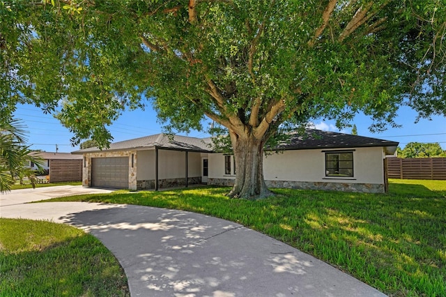 3136 Webber St, Sarasota, FL 34239 - ranch-style house with stone siding, concrete driveway, an attached garage, and stucco siding