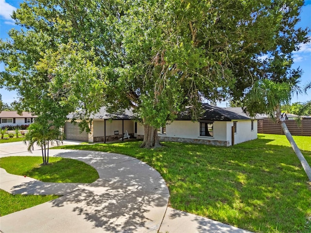 3136 Webber St, Sarasota, FL 34239 - view of front of home with driveway, stucco siding, a garage, and stone siding