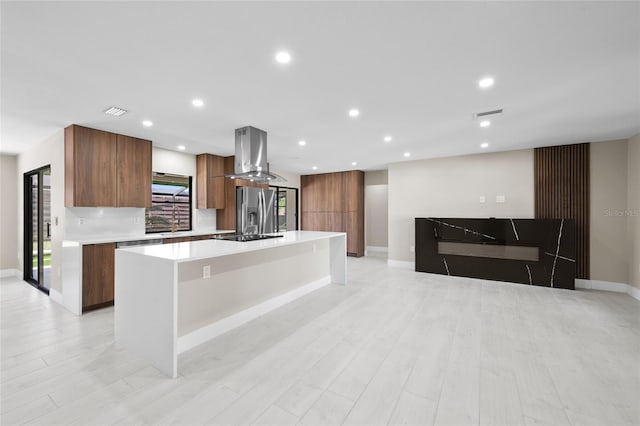 3136 Webber St, Sarasota, FL 34239 - kitchen featuring wall chimney exhaust hood, stainless steel refrigerator with ice dispenser, modern cabinets, light countertops, and a large island