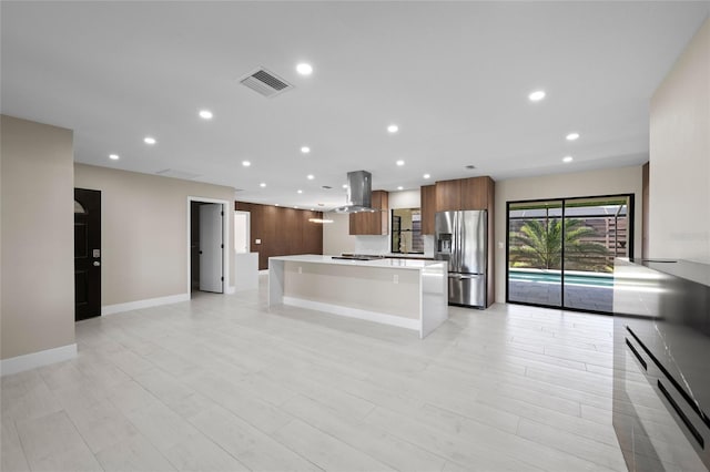 3136 Webber St, Sarasota, FL 34239 - kitchen with stainless steel refrigerator with ice dispenser, island range hood, light countertops, a center island, and recessed lighting