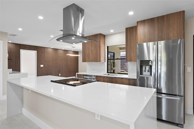 3136 Webber St, Sarasota, FL 34239 - kitchen featuring island range hood, stainless steel appliances, modern cabinets, light countertops, and brown cabinets