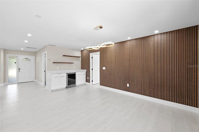3136 Webber St, Sarasota, FL 34239 - unfurnished living room featuring wine cooler, light wood-style flooring, recessed lighting, and a fireplace