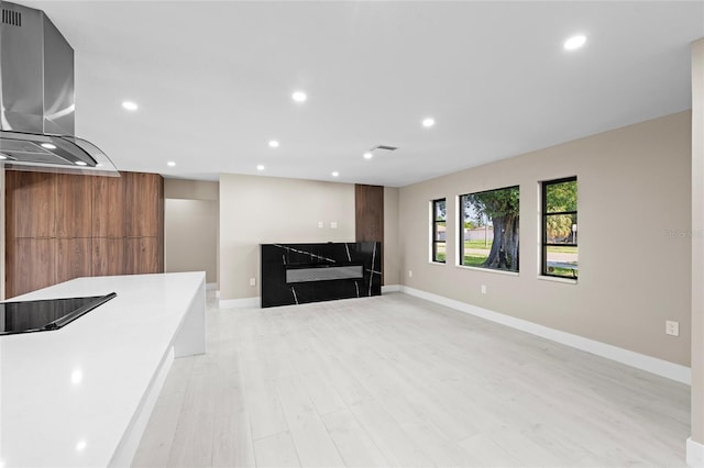 3136 Webber St, Sarasota, FL 34239 - unfurnished living room featuring recessed lighting, a high end fireplace, and light wood-style floors