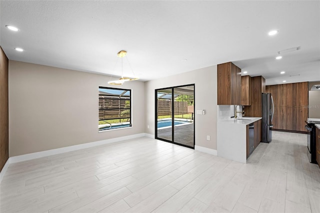 3136 Webber St, Sarasota, FL 34239 - kitchen with modern cabinets, light countertops, recessed lighting, freestanding refrigerator, and pendant lighting