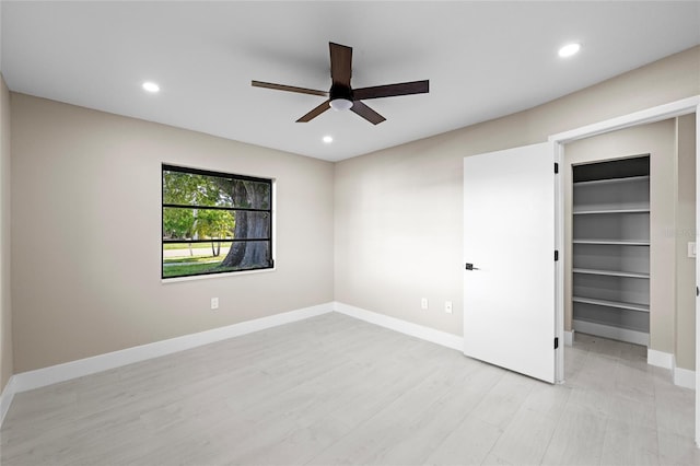 3136 Webber St, Sarasota, FL 34239 - unfurnished bedroom featuring a spacious closet, recessed lighting, light wood finished floors, a ceiling fan, and a closet