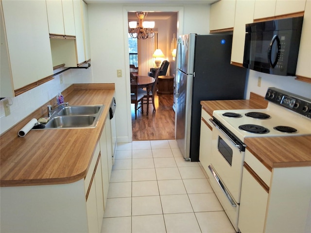 515 30th Ave W Unit H401, Bradenton, FL 34205 - kitchen with white appliances, wooden counters, and a chandelier