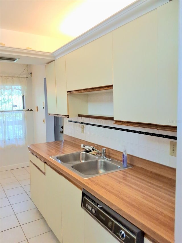 515 30th Ave W Unit H401, Bradenton, FL 34205 - kitchen featuring dishwasher, backsplash, light tile patterned floors, butcher block counters, and cream cabinets