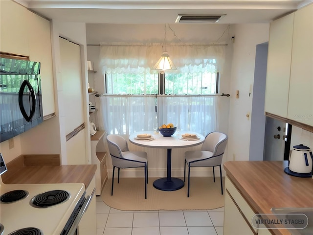 515 30th Ave W Unit H401, Bradenton, FL 34205 - dining space featuring light tile patterned floors