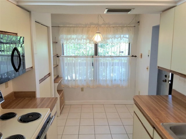 515 30th Ave W Unit H401, Bradenton, FL 34205 - kitchen featuring black microwave, white electric range oven, wood counters, and white cabinetry