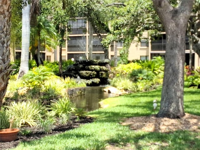 515 30th Ave W Unit H401, Bradenton, FL 34205 - surrounding community with a small pond