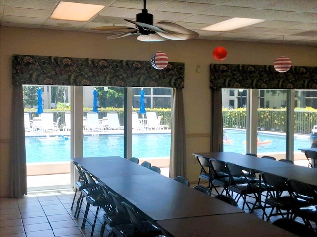 515 30th Ave W Unit H401, Bradenton, FL 34205 - tiled dining room featuring a drop ceiling, healthy amount of natural light, and a ceiling fan