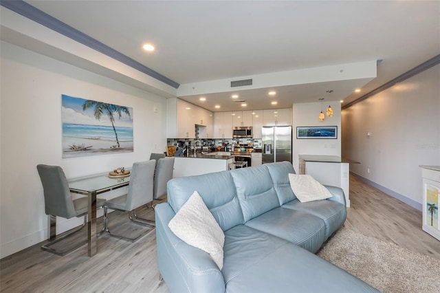 1709 N Tamiami Trl Unit A313, Sarasota, FL 34234 - living area with light wood-style flooring and recessed lighting