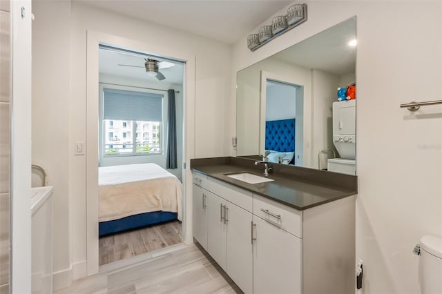 1709 N Tamiami Trl Unit A313, Sarasota, FL 34234 - bathroom featuring ensuite bathroom, stacked washer / dryer, and vanity