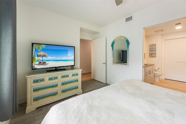 1709 N Tamiami Trl Unit A313, Sarasota, FL 34234 - bedroom with wood finished floors, ensuite bath, and ceiling fan