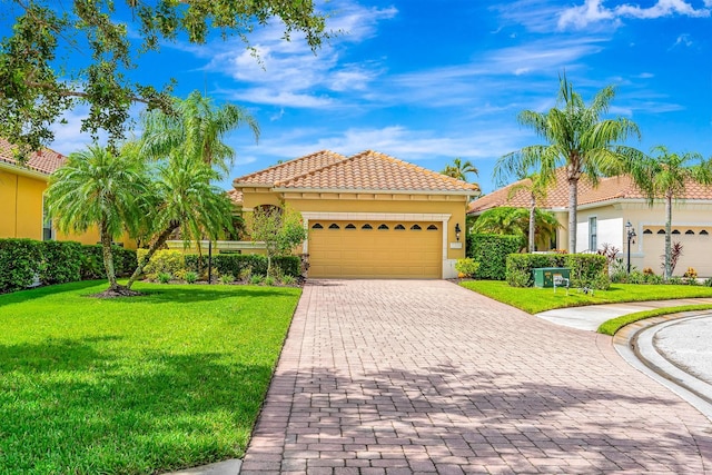 7314 Wexford Ct, Lakewood Ranch, FL 34202 - mediterranean / spanish home with stucco siding, a garage, decorative driveway, a front yard, and a tiled roof