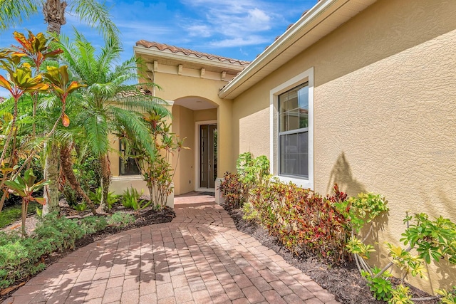 7314 Wexford Ct, Lakewood Ranch, FL 34202 - doorway to property with stucco siding and a patio area