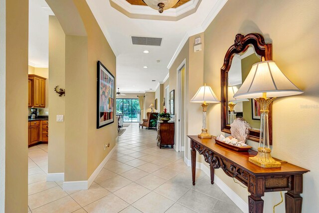 7314 Wexford Ct, Lakewood Ranch, FL 34202 - hall featuring light tile patterned floors, crown molding, and arched walkways