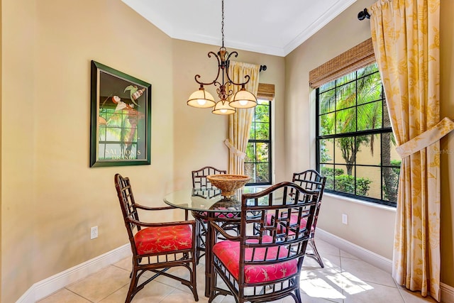 7314 Wexford Ct, Lakewood Ranch, FL 34202 - dining area featuring a chandelier, light tile patterned floors, and crown molding