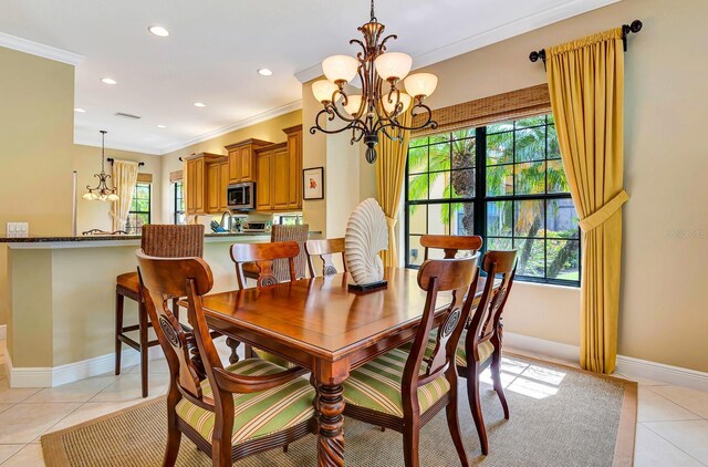7314 Wexford Ct, Lakewood Ranch, FL 34202 - dining room with a chandelier, crown molding, light tile patterned floors, and recessed lighting