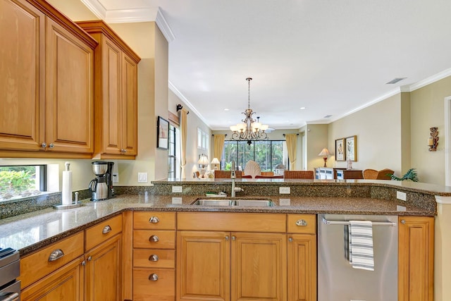 7314 Wexford Ct, Lakewood Ranch, FL 34202 - kitchen with brown cabinets, plenty of natural light, dark stone counters, a chandelier, and ornamental molding