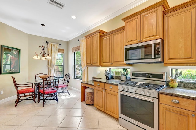 7314 Wexford Ct, Lakewood Ranch, FL 34202 - kitchen with stainless steel appliances, crown molding, light tile patterned flooring, healthy amount of natural light, and brown cabinets
