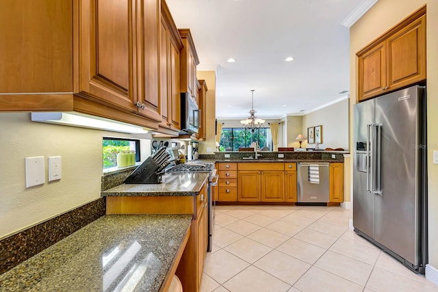 7314 Wexford Ct, Lakewood Ranch, FL 34202 - kitchen featuring stainless steel appliances, brown cabinets, plenty of natural light, a chandelier, and crown molding