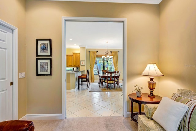 7314 Wexford Ct, Lakewood Ranch, FL 34202 - corridor with a chandelier, light tile patterned flooring, crown molding, and light carpet