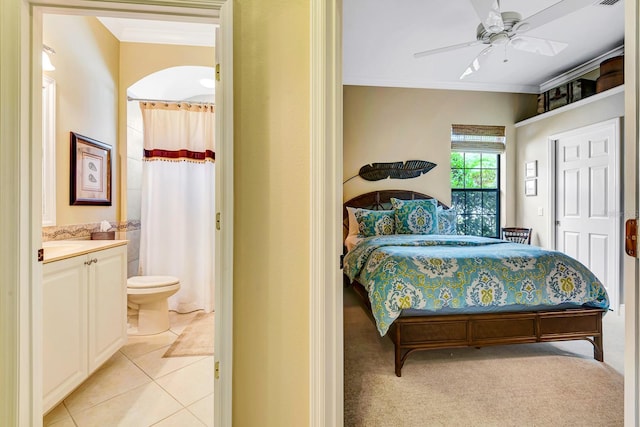 7314 Wexford Ct, Lakewood Ranch, FL 34202 - bedroom featuring crown molding, connected bathroom, light tile patterned floors, and a ceiling fan