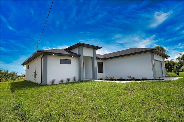 366 Fordham Rd, Venice, FL 34293 - back of property with a garage, stucco siding, and a lawn