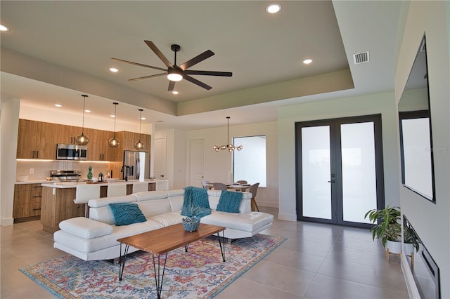 366 Fordham Rd, Venice, FL 34293 - living area with ceiling fan, light tile patterned floors, recessed lighting, a raised ceiling, and a chandelier