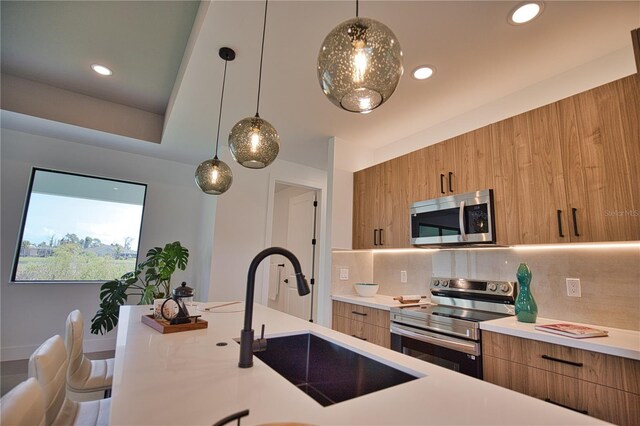 366 Fordham Rd, Venice, FL 34293 - kitchen featuring stainless steel appliances, modern cabinets, light countertops, brown cabinets, and recessed lighting
